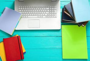 Workplace with copy space and colorful accessories on blue wooden table. Top view photo