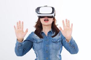 Amazed caucasian woman looking in a VR goggles and gesturing by hands isolated on white background. Virtual reality concept. Copy space and mock up photo