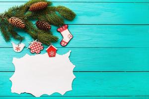 Christmas card and tree with copy space on blue wooden background. Top view photo