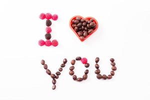 Candy and sweets isolated on white background. Heart shape. Top view. Selective focus. Copy space and mock up photo