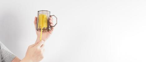 Clean and wash dish concept. Man hand washing drink glass on white background. photo