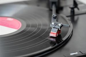 Record player playing a vinyl record. Black platter