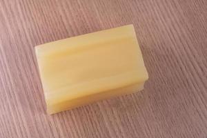 Bar of glycerin soap on the wooden background photo