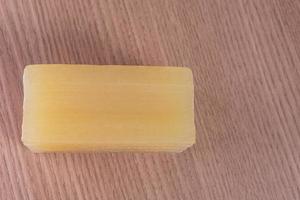 Bar of glycerin soap on the wooden background photo