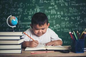 Boy write book in the classroom photo