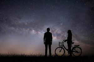 Silhouette young couple in love enjoy good time together during sunset. photo