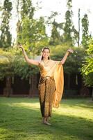 Beautiful Woman wearing typical Thai dress photo