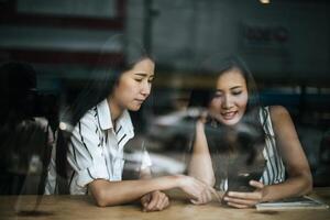 Two beautiful women talking everything together at coffee shop cafe photo