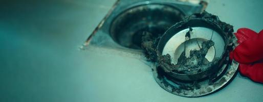 Drain cleaning. Clogged and dirty sewer pipes floor drain. photo