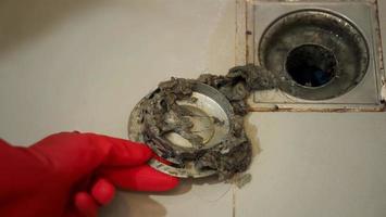 Drain cleaning. Clogged and dirty sewer pipes floor drain. photo