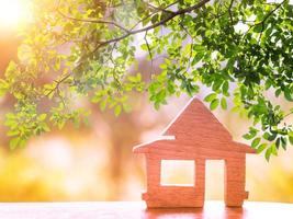 Sunshine through wooden House model there space. home, housing and real estate concept photo