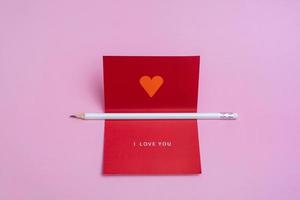 Valentines day greeting mockup with blank card and white pencil. Creative flat lay empty space. photo