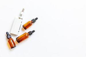 Vaping device e-cigarette electronic cigarette and liquid bottles isolated on white background. Vape device for alternative smoking. Vaping shop concept. Gadget for vaper. Vaping accessories. photo