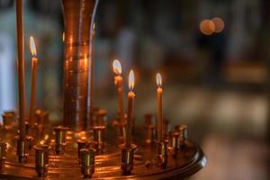 Iglesia Ortodoxa. cristiandad. decoración interior festiva con velas encendidas e icono en la iglesia ortodoxa tradicional en vísperas de pascua o navidad. religión fe orar símbolo. foto