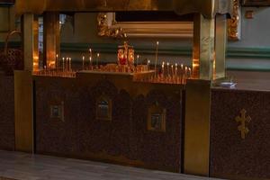 Orthodox Church. Christianity. Festive interior decoration with burning candles and icon in traditional Orthodox Church on Easter Eve or Christmas. Religion faith pray symbol. photo