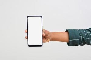 Young indian college student showing smartphone Screen on white background. photo