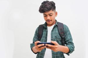 Indian college student using smartphone on white background. photo