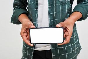Young indian college student showing smartphone Screen on white background. photo