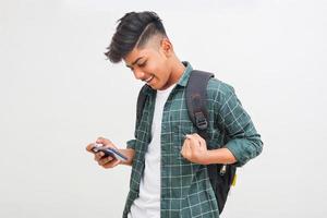 Indian college student using smartphone on white background. photo