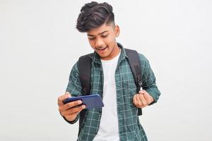 Indian college student using smartphone on white background. photo