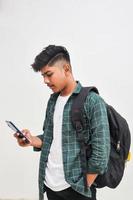 Indian college student using smartphone on white background. photo