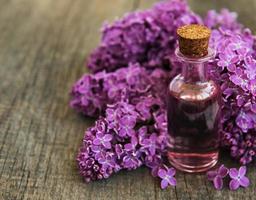 Essential oil with lilac flowers photo