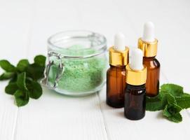 essential aroma oil with massage salt and mint photo