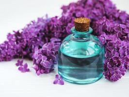 Essential oil with lilac flowers photo