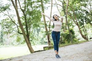 Asian woman listening favorite music on headphones. Happy time and relax. photo