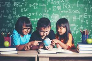 kid observing or studying educational globe model in the classroom. photo