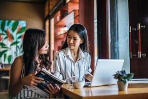 Two beautiful women talking everything together at coffee shop cafe photo