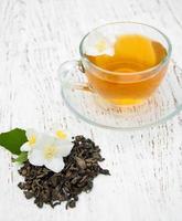 Cup of tea with jasmine flowers photo