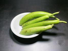 bottle gourd, Lagenaria siceraria isolated on black background. photo