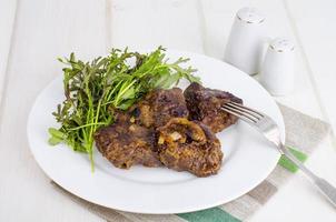 Fried beef liver with lettuce mix. photo