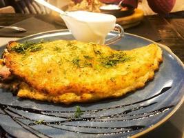 Potato pancake with mushrooms in pan photo