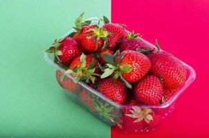 Fresh sweet red strawberries in plastic container. photo