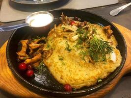 Potato pancake with mushrooms in pan photo