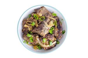 Fried liver with onions in bowl on white background. photo