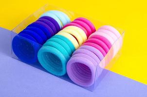 Colored hair ties on bright background. Photo