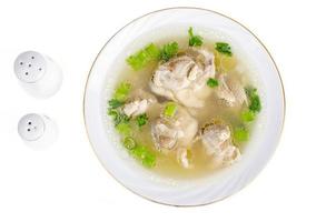 Broth with chicken meat Isolated on White background photo