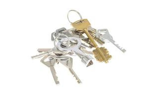 Bundles of old keys on white background. photo