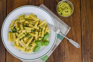 Penne pasta with pesto sauce. Italian cuisine. photo