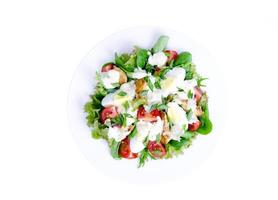 White plate with vegetable salad with egg and mayonnaise, isolated. photo