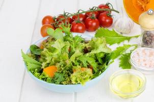 Healthy pumpkin salad with tomato, lettuce and seeds. photo