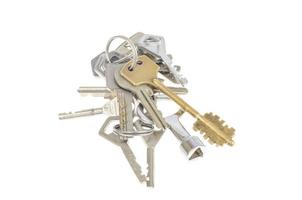 Bundles of old keys on white background. photo