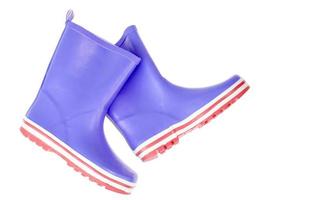Children's pink rubber boots for walking on white. photo