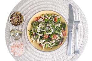 Salad of lettuce leaves, tomatoes and squid. photo