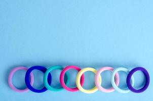 Colored hair ties on bright background. Photo