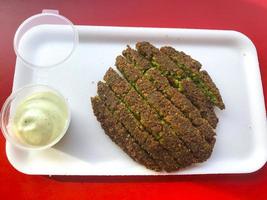 Falafel with sauce on table in cafe. Studio Photo