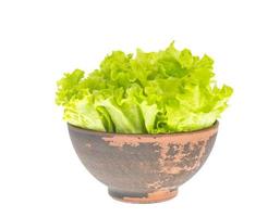 Fresh green salad leaves in clay bowl. photo